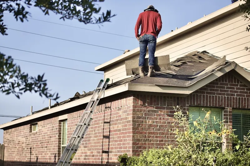 Professional roofer working on a residential roof in East Lynn